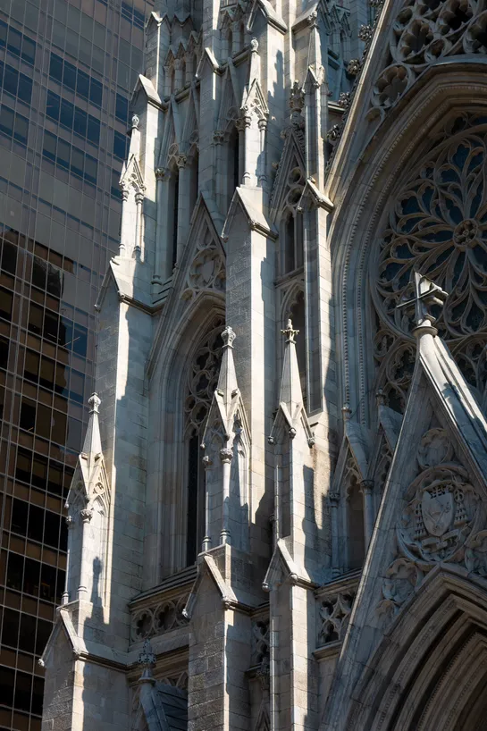 A cathedral right next to a modern skyscraper