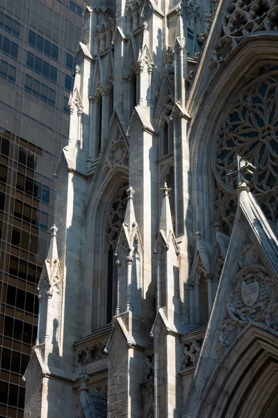A cathedral right next to a modern skyscraper
