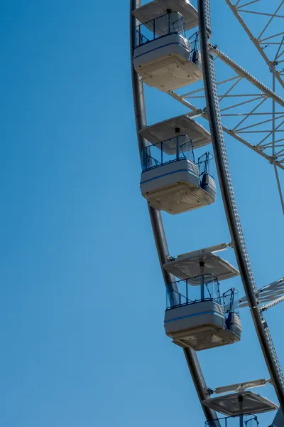 Cabins of a ferris wheel, a clear sky in the background
