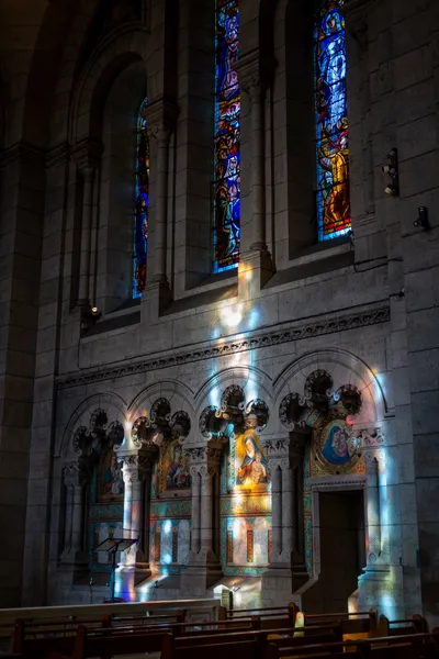 The sun coming through stained glass, coloring the inside of this church