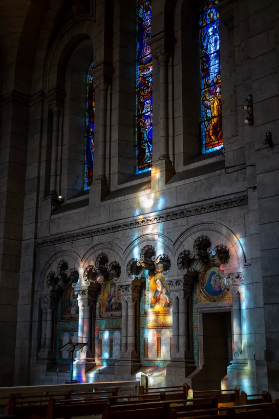 The sun coming through stained glass, coloring the inside of this church