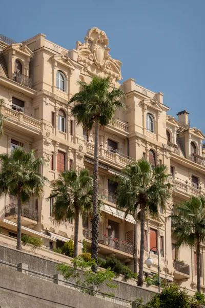 A stone building, palm trees in front