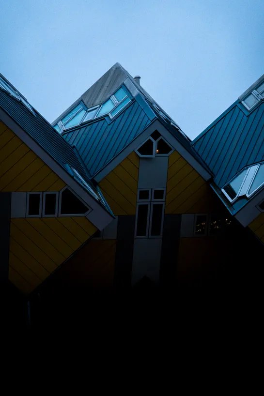 Barely lit houses, they are modern constructions, tilted cubes