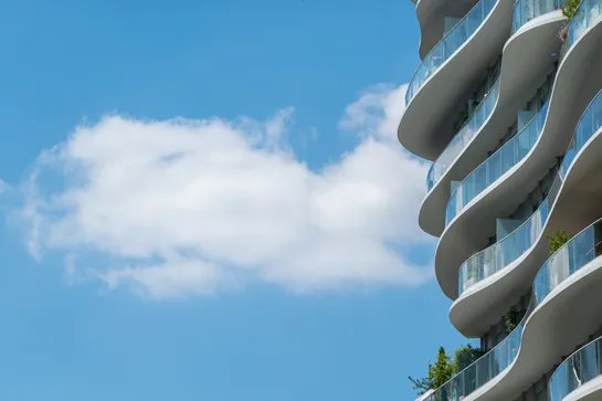 Clouds passing by a modern building
