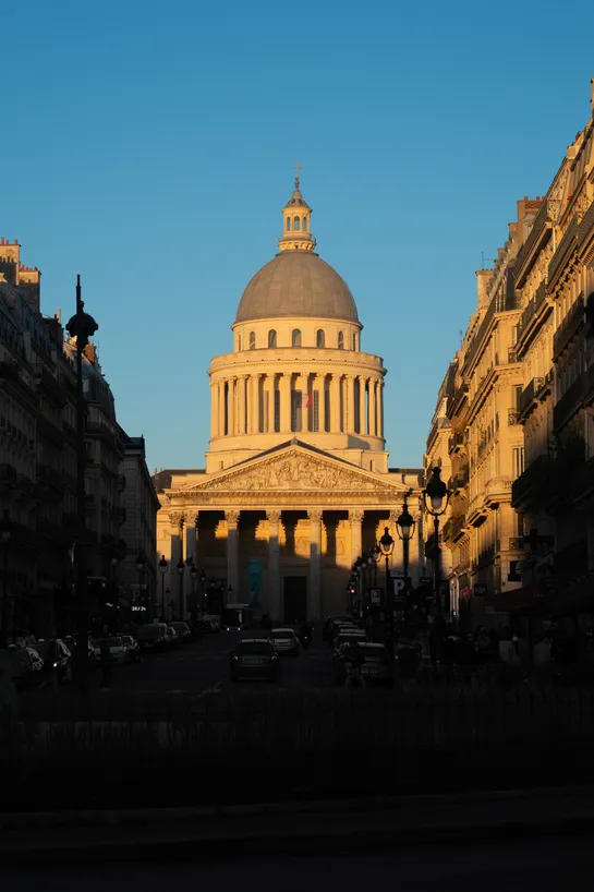 The Pantheon bathed in the light of the setting sun, the street and cars in front can barely be seen