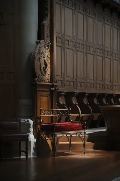 A traditional looking chair amid ornamental woodwork