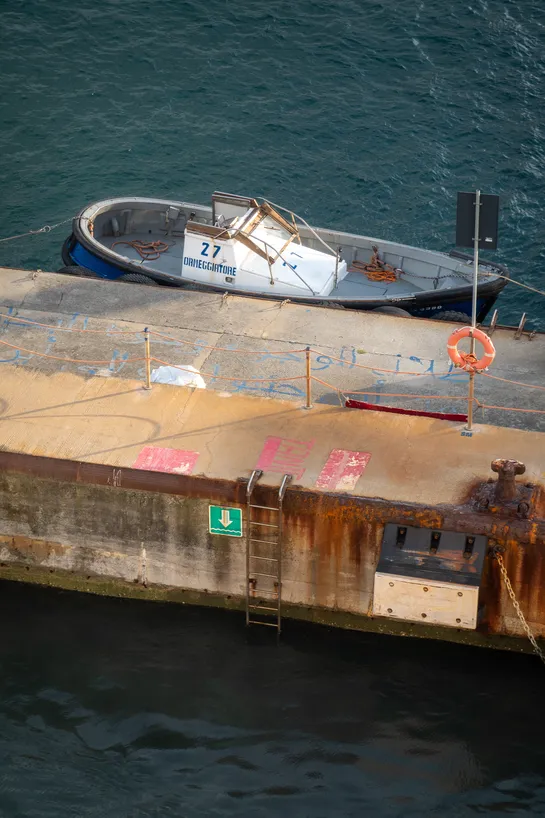 A quay with one boat parked