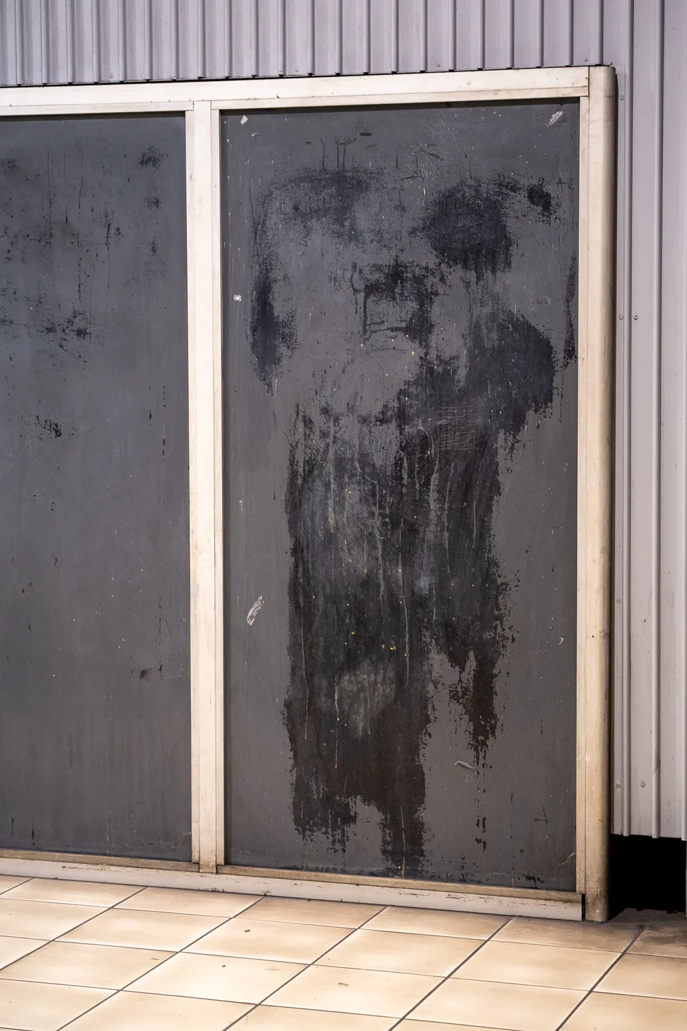 Black markings on a grey metal frame