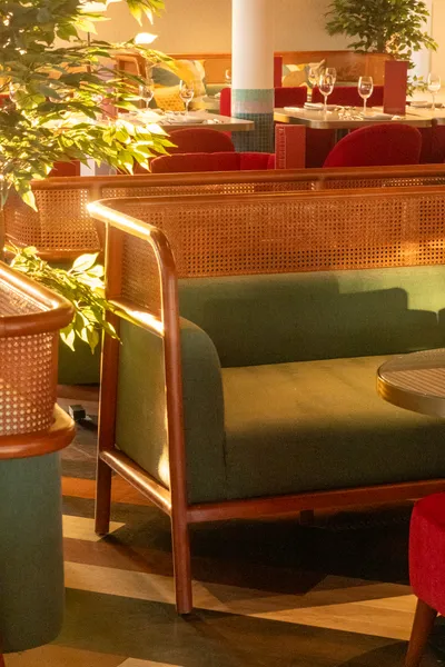 The interior of a restaurant, bathed in yellow light from the sunset