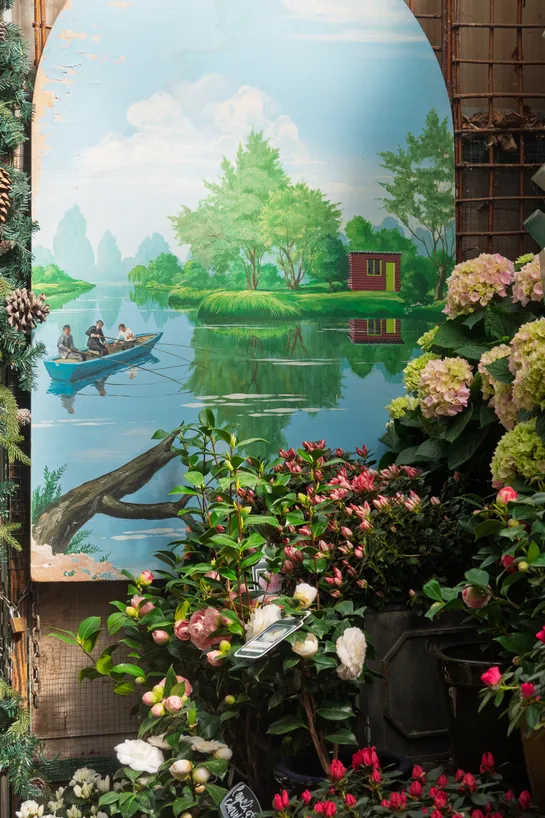A nature painting next to flowers