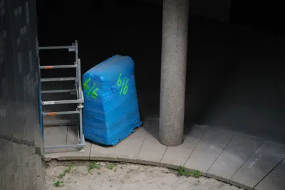 Construction equipment left in a dark concrete place, dry dirt without barely any grass