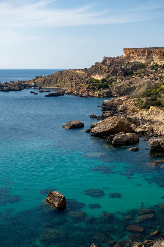 Coastline with rugged terrain, turquoise water.